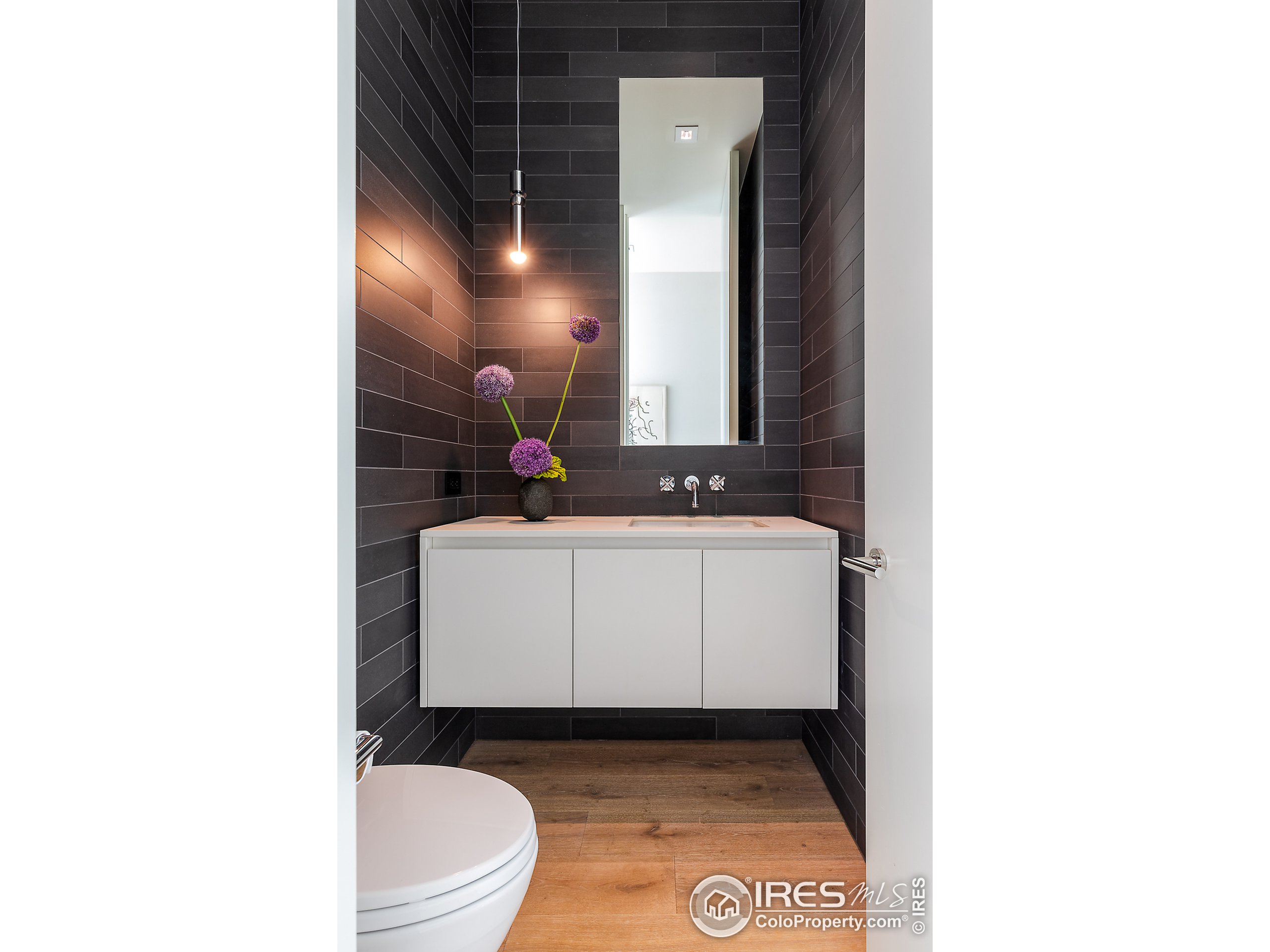 Undisclosed Address Boulder, CO 80302 - Photo 30 of 40 a bathroom with a sink a toilet and mirror