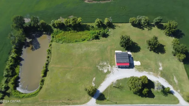 an aerial view of a house with a yard