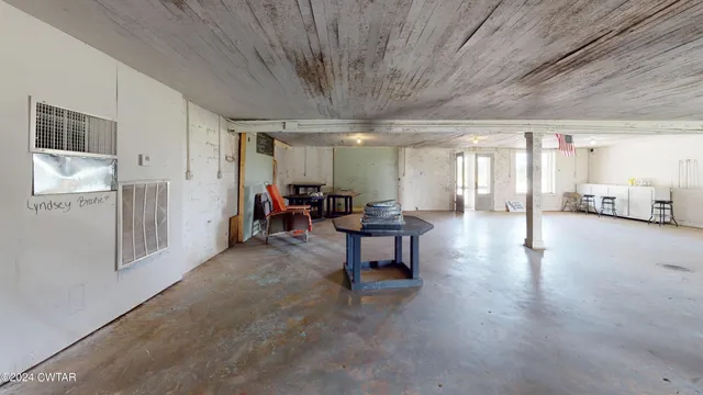 a living room with furniture and a dining table with wooden floor
