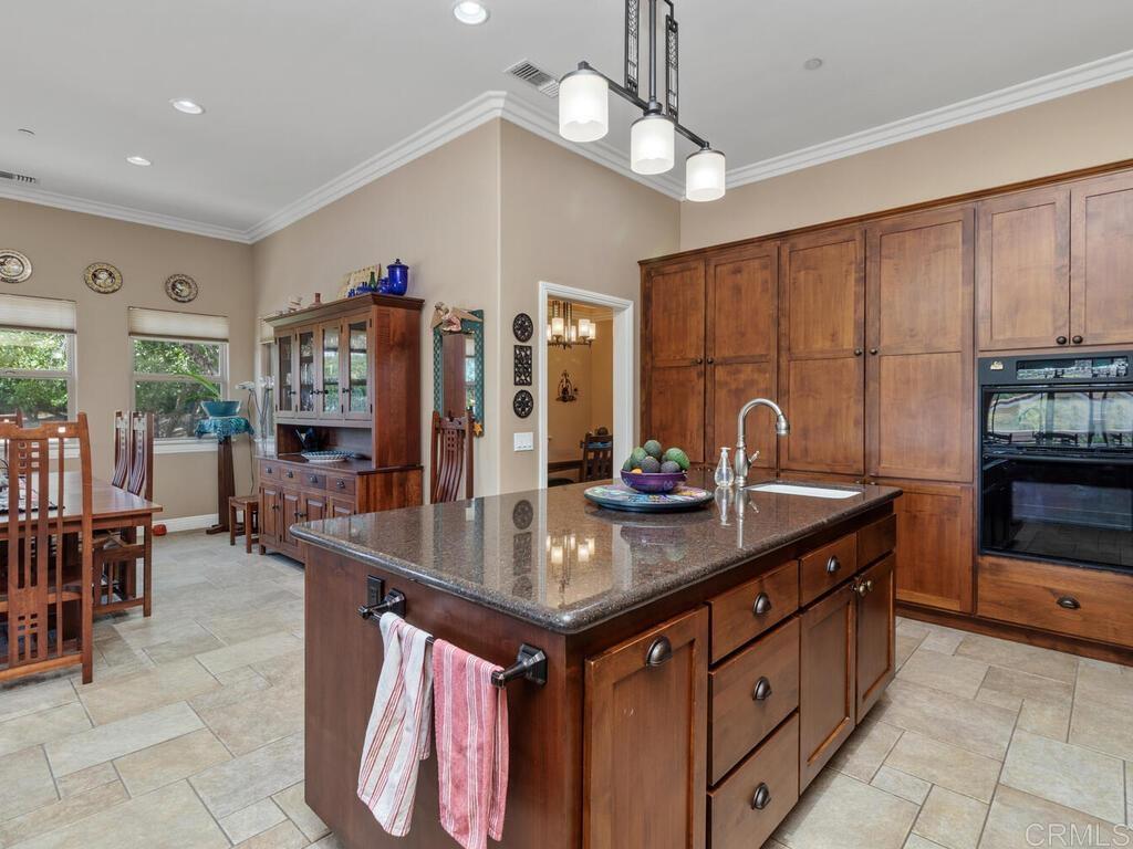 1845 Acacia Lane Fallbrook, CA 92028 - Photo 13 of 54 a kitchen with stainless steel appliances granite countertop a sink a stove and a refrigerator
