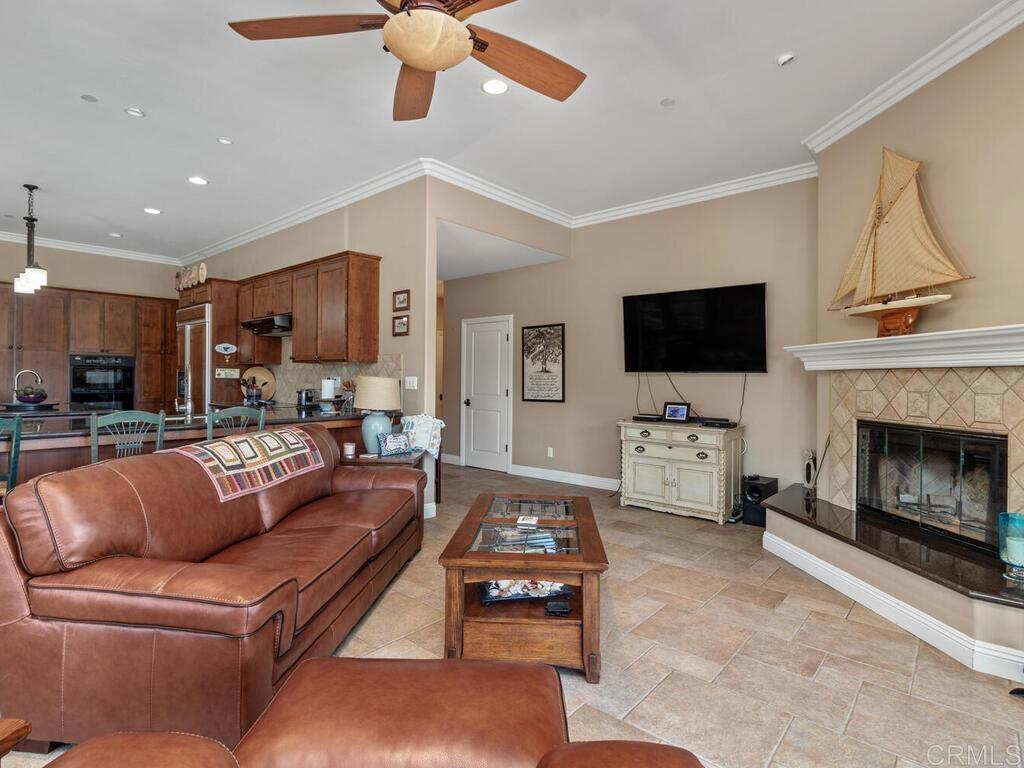 1845 Acacia Lane Fallbrook, CA 92028 - Photo 17 of 54 a living room with furniture a flat screen tv and a fireplace