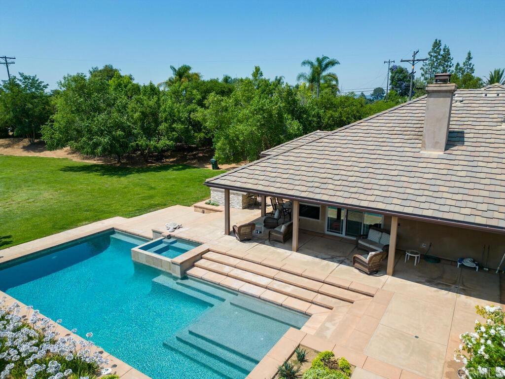 1845 Acacia Lane Fallbrook, CA 92028 - Photo 45 of 54 a view of a patio with table and chairs with wooden floor and fence