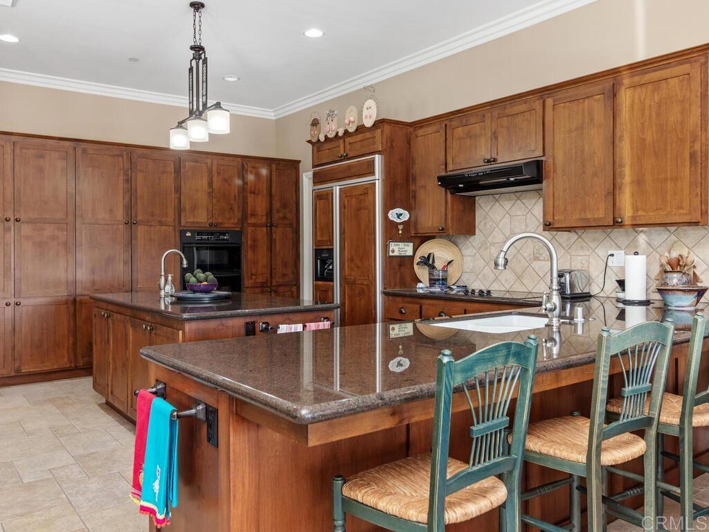 1845 Acacia Lane Fallbrook, CA 92028 - Photo 8 of 54 a kitchen with stainless steel appliances granite countertop a sink and cabinets