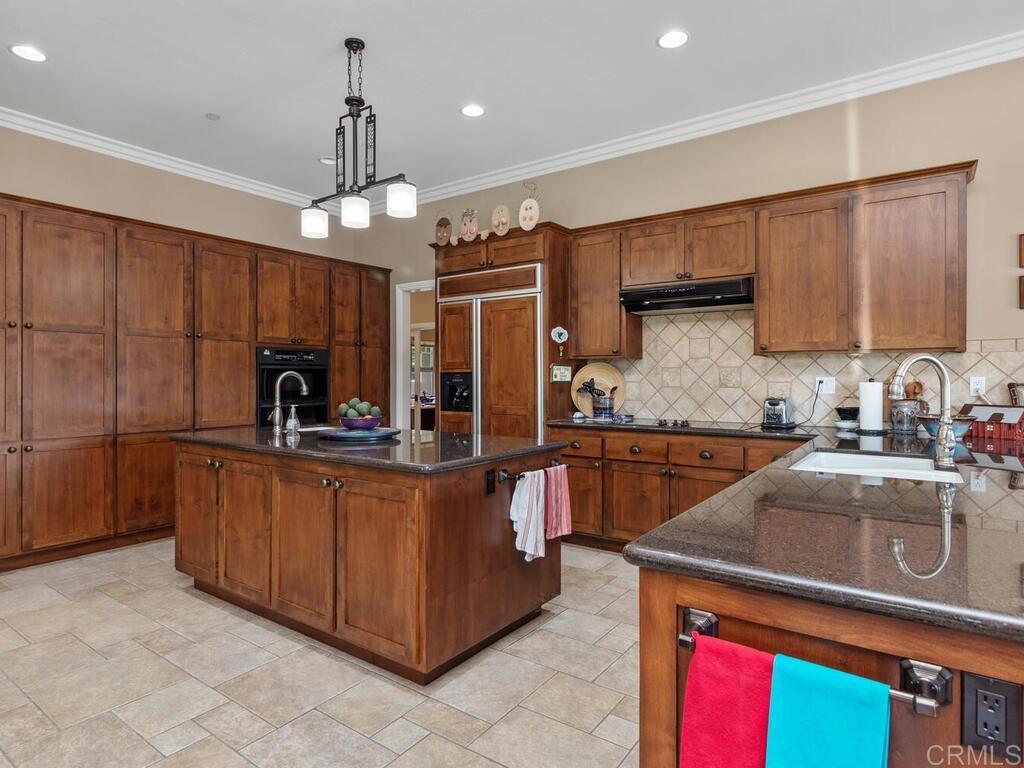 1845 Acacia Lane Fallbrook, CA 92028 - Photo 10 of 54 a kitchen with granite countertop a stove oven and a counter top space