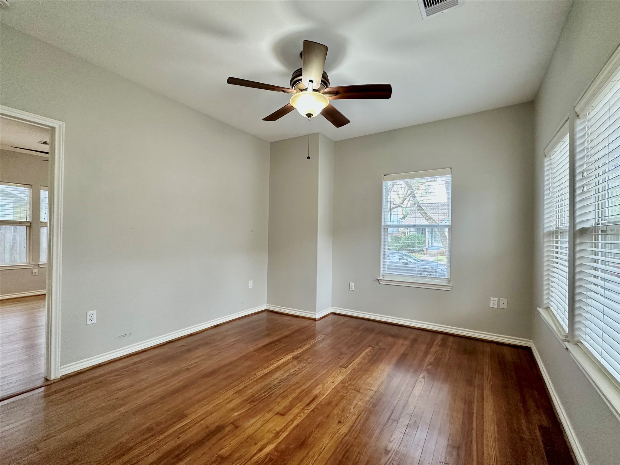 112 Munford Street Houston, TX 77008 - Photo 17 of 28 an empty room with wooden floor chandelier fan and windows