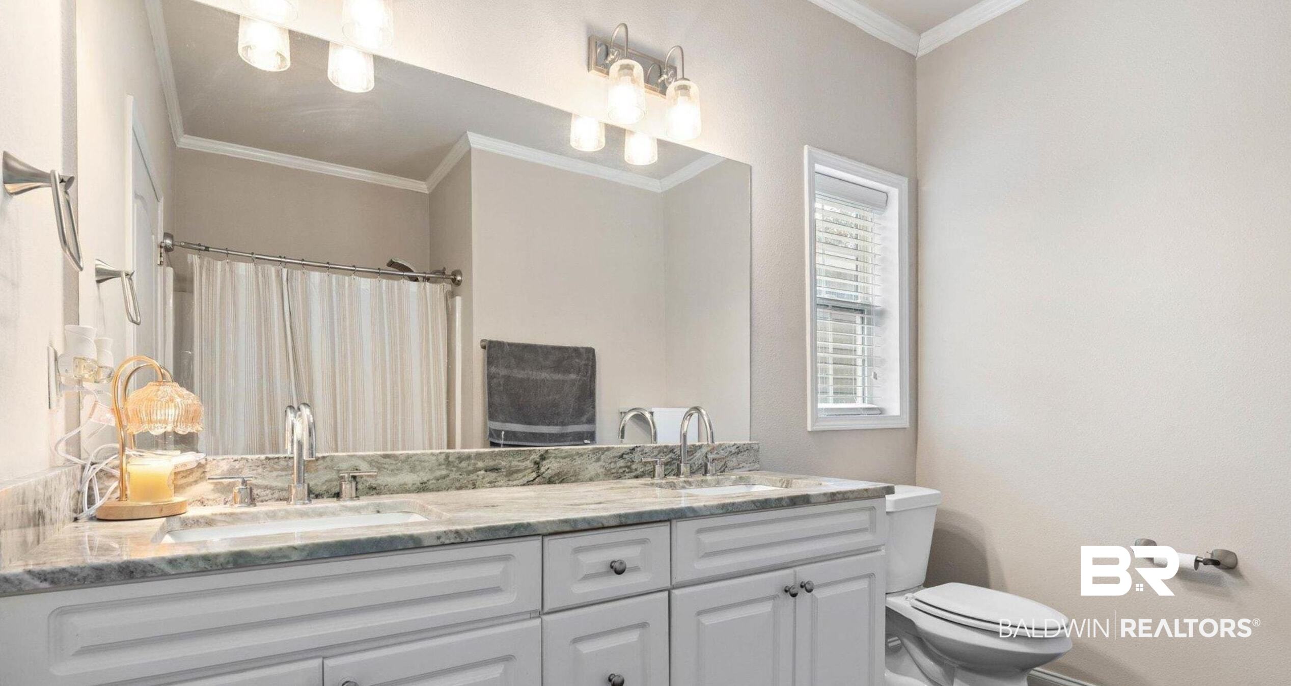 25806 Pollard Road, Unit 203 Daphne, AL 36526 - Photo 10 of 14 Bathroom with ornamental molding, dark wood-style floors, double vanity, and a shower with curtain
