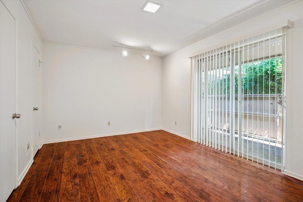 11400 Park Central Place, Unit C Dallas, TX 75230 - Photo 12 of 20 a view of empty room with wooden floor and fan