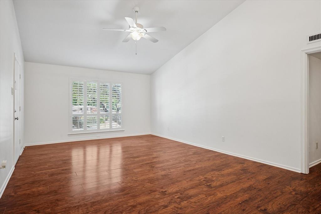 11400 Park Central Place, Unit C Dallas, TX 75230 - Photo 2 of 20 an empty room with wooden floor and window