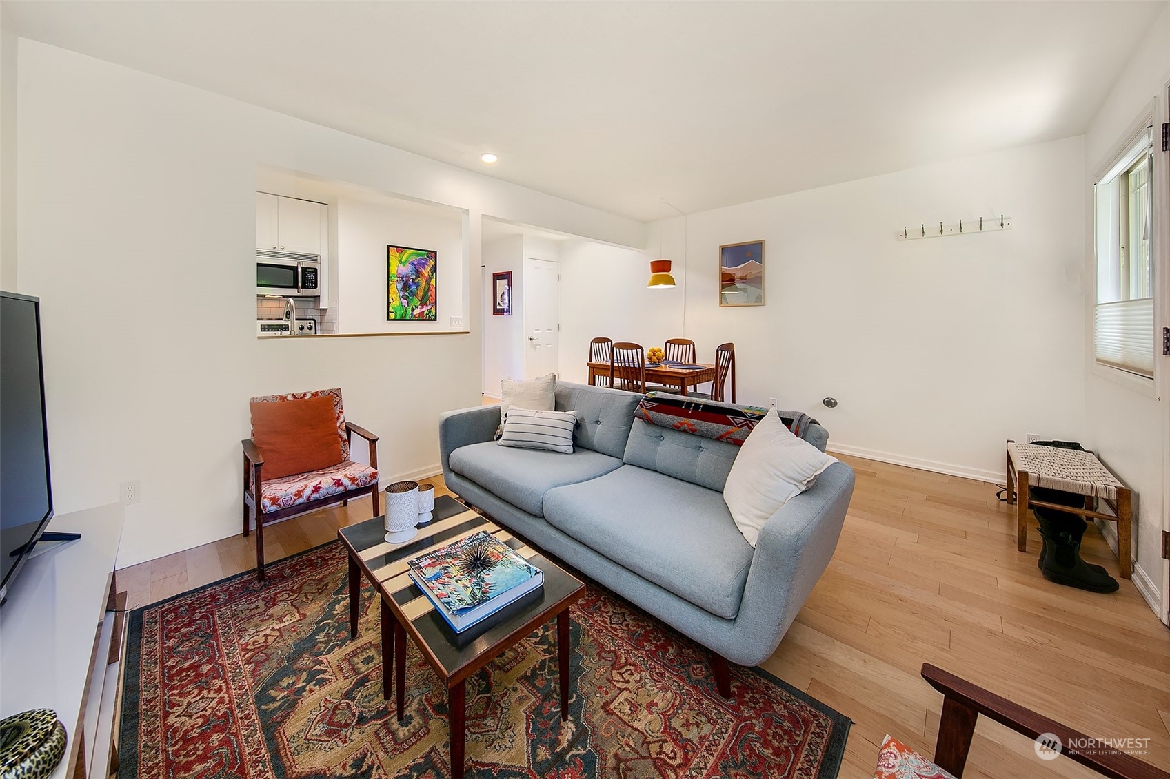 3636 Evanston Avenue North, Unit 4 Seattle, WA 98103 - Photo 11 of 19 a living room with furniture and a flat screen tv