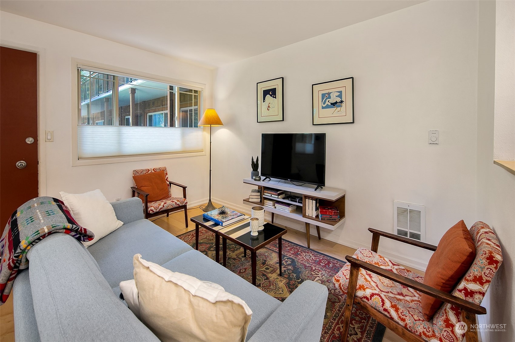 3636 Evanston Avenue North, Unit 4 Seattle, WA 98103 - Photo 12 of 19 a living room with furniture and a flat screen tv