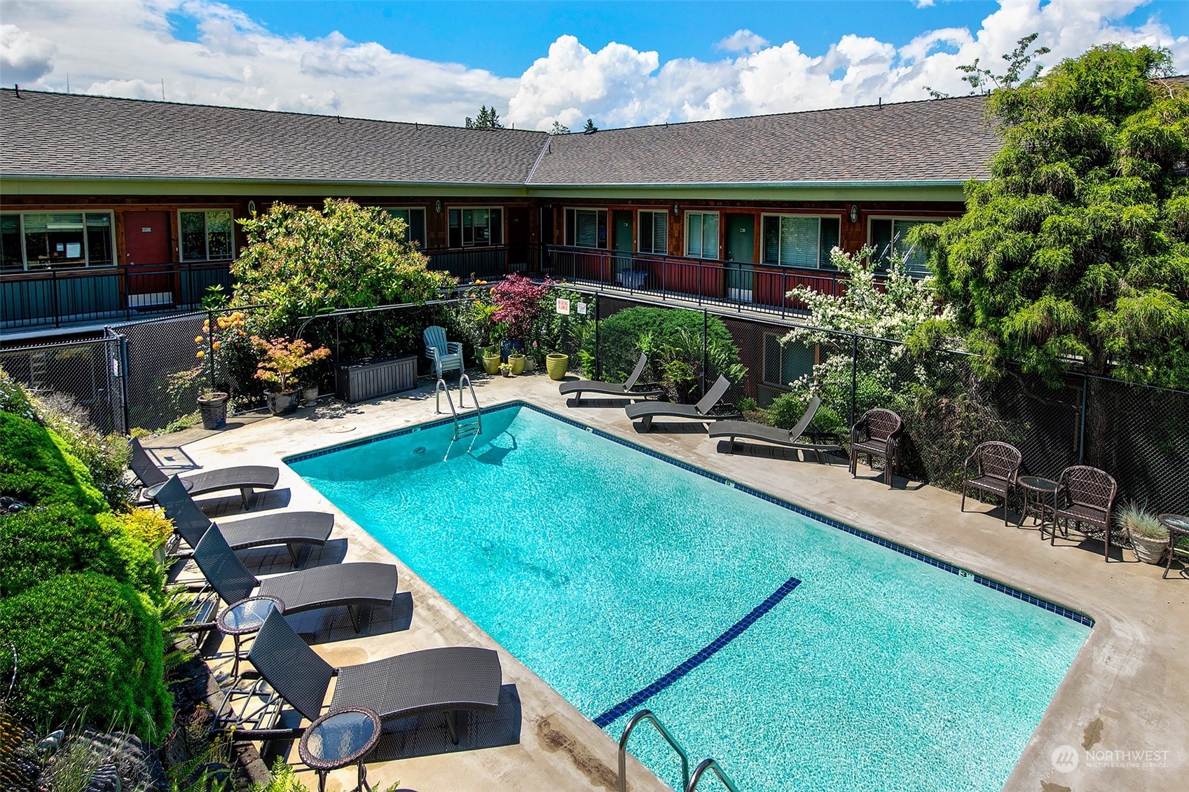 3636 Evanston Avenue North, Unit 4 Seattle, WA 98103 - Photo 14 of 19 a view of swimming pool with outdoor seating and a garden