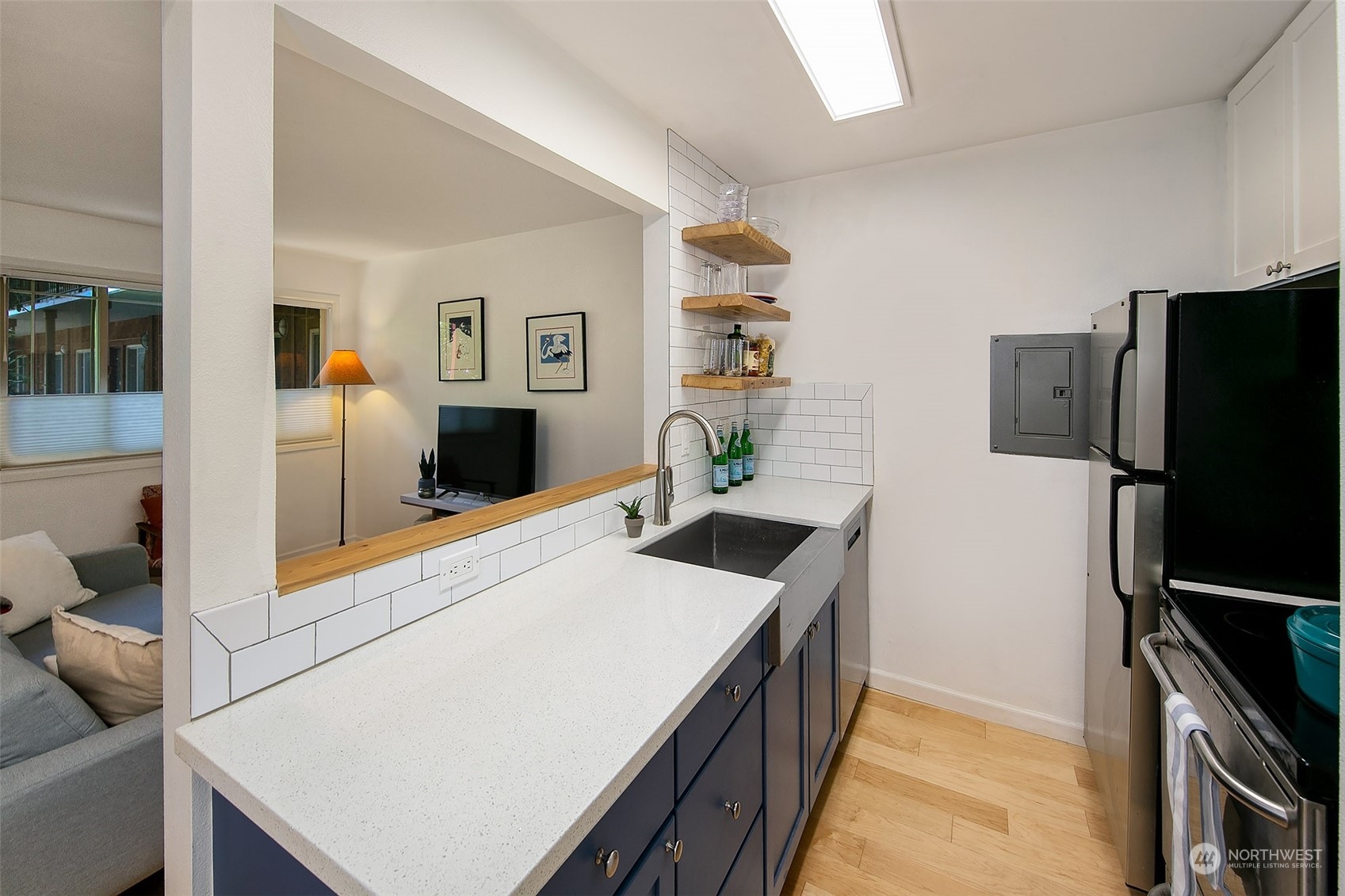 3636 Evanston Avenue North, Unit 4 Seattle, WA 98103 - Photo 5 of 19 a kitchen with stainless steel appliances a stove refrigerator and a refrigerator