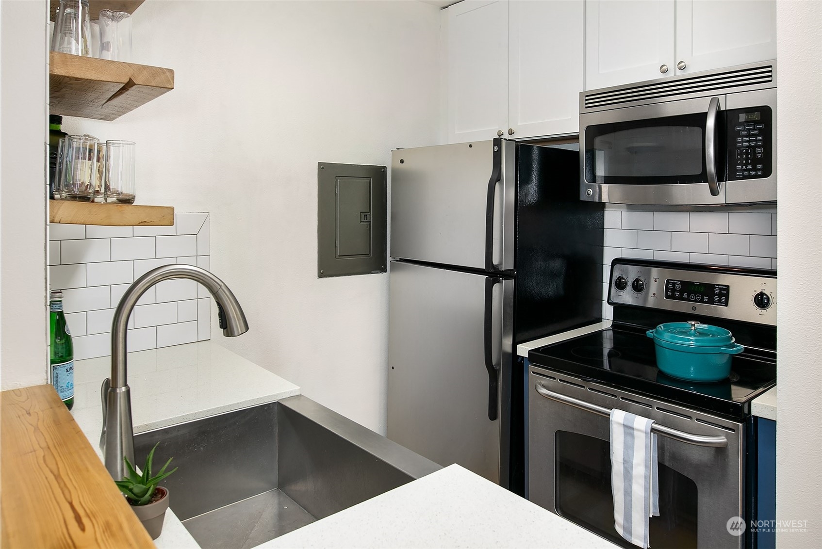 3636 Evanston Avenue North, Unit 4 Seattle, WA 98103 - Photo 6 of 19 a kitchen with a refrigerator stove and microwave