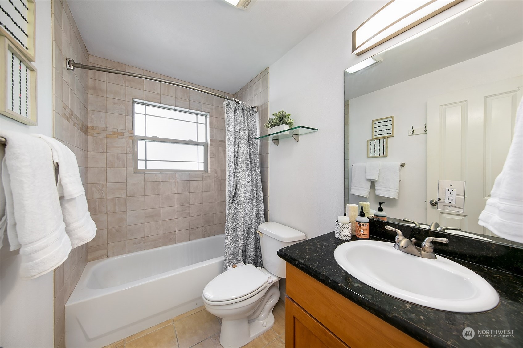 3636 Evanston Avenue North, Unit 4 Seattle, WA 98103 - Photo 8 of 19 a bathroom with a granite countertop sink mirror toilet and bathtub