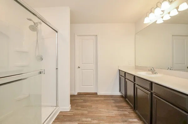 a bathroom with a double vanity sink and a mirror