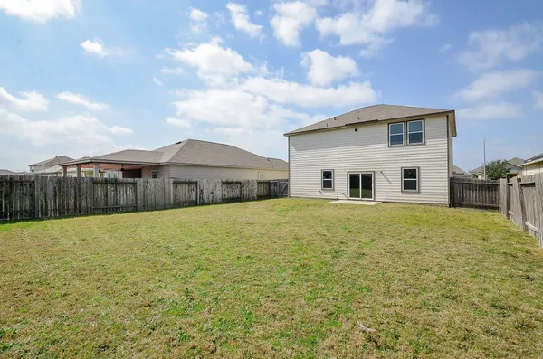a front view of house with yard and car parked