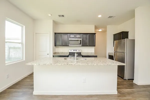 a large kitchen with stainless steel appliances