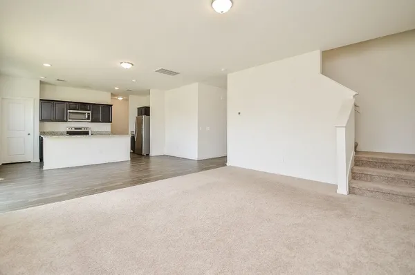 a view of a kitchen with a sink and a refrigerator