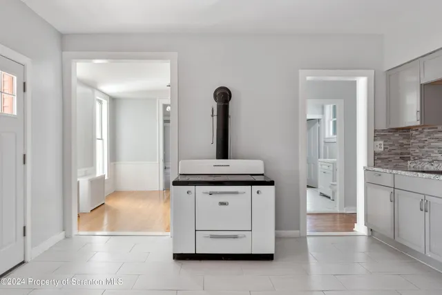 a kitchen with a sink a stove and a refrigerator