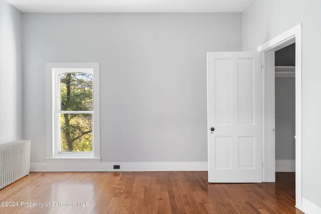 a view of a livingroom with wooden floor and staircase
