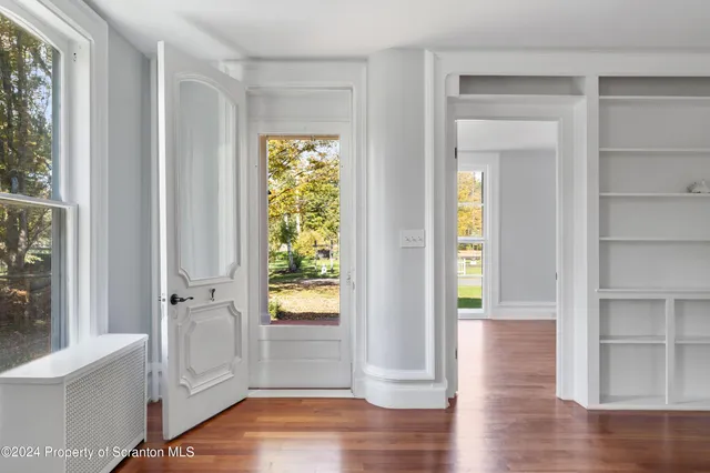 wooden floor in an empty room with a window