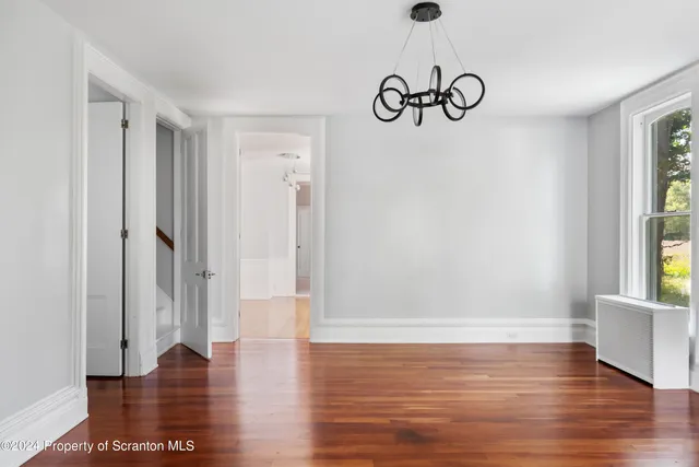 a view of room with window and hardwood floor