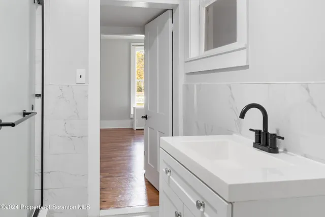 a bathroom with a sink and mirror