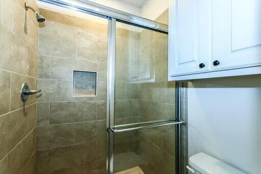 a bathroom with a shower and a sink