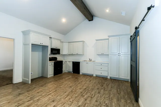 a kitchen with white cabinets and stainless steel appliances