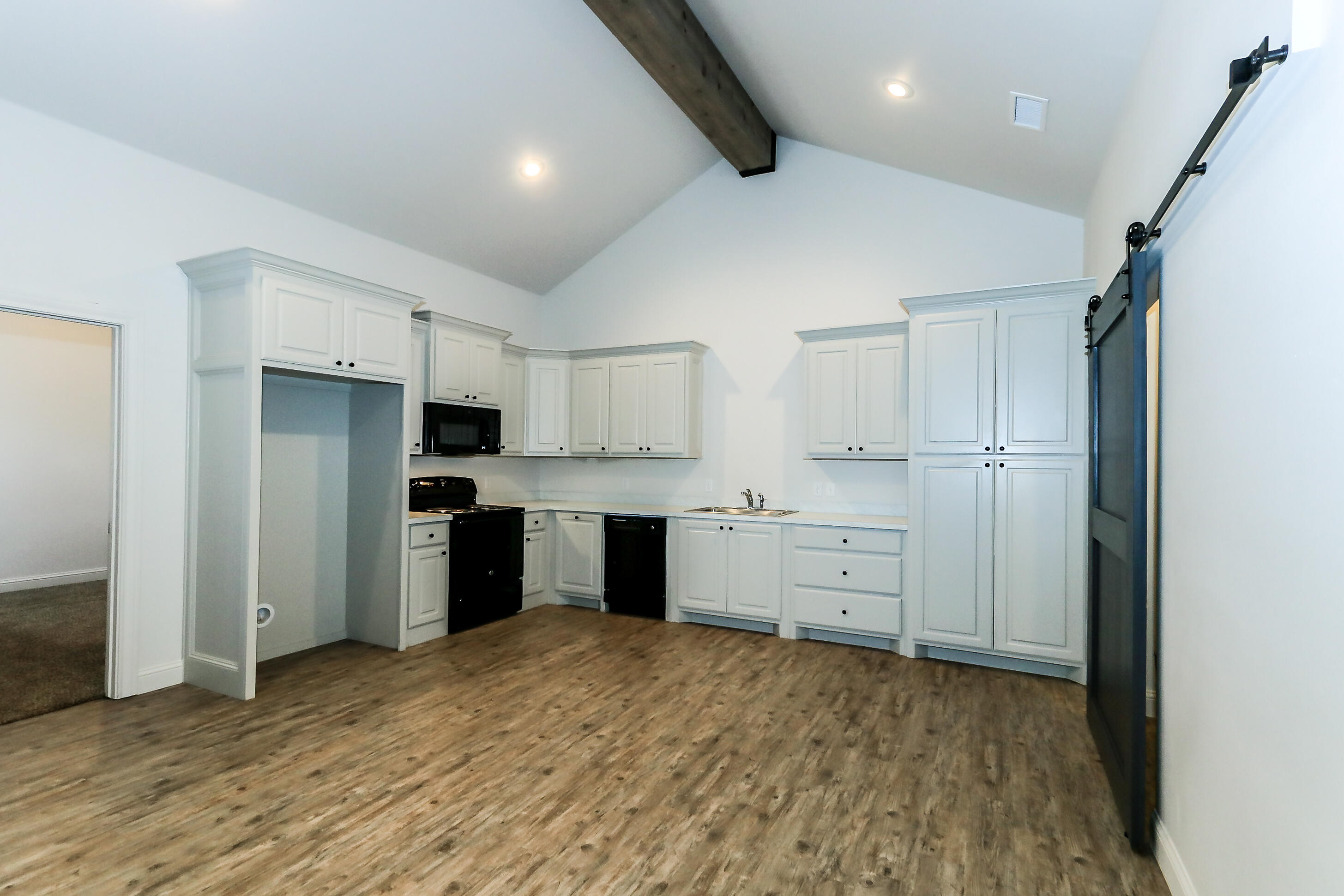 2510 112th Street, Unit B Lubbock, TX 79423 - Photo 15 of 28 a kitchen with white cabinets and stainless steel appliances