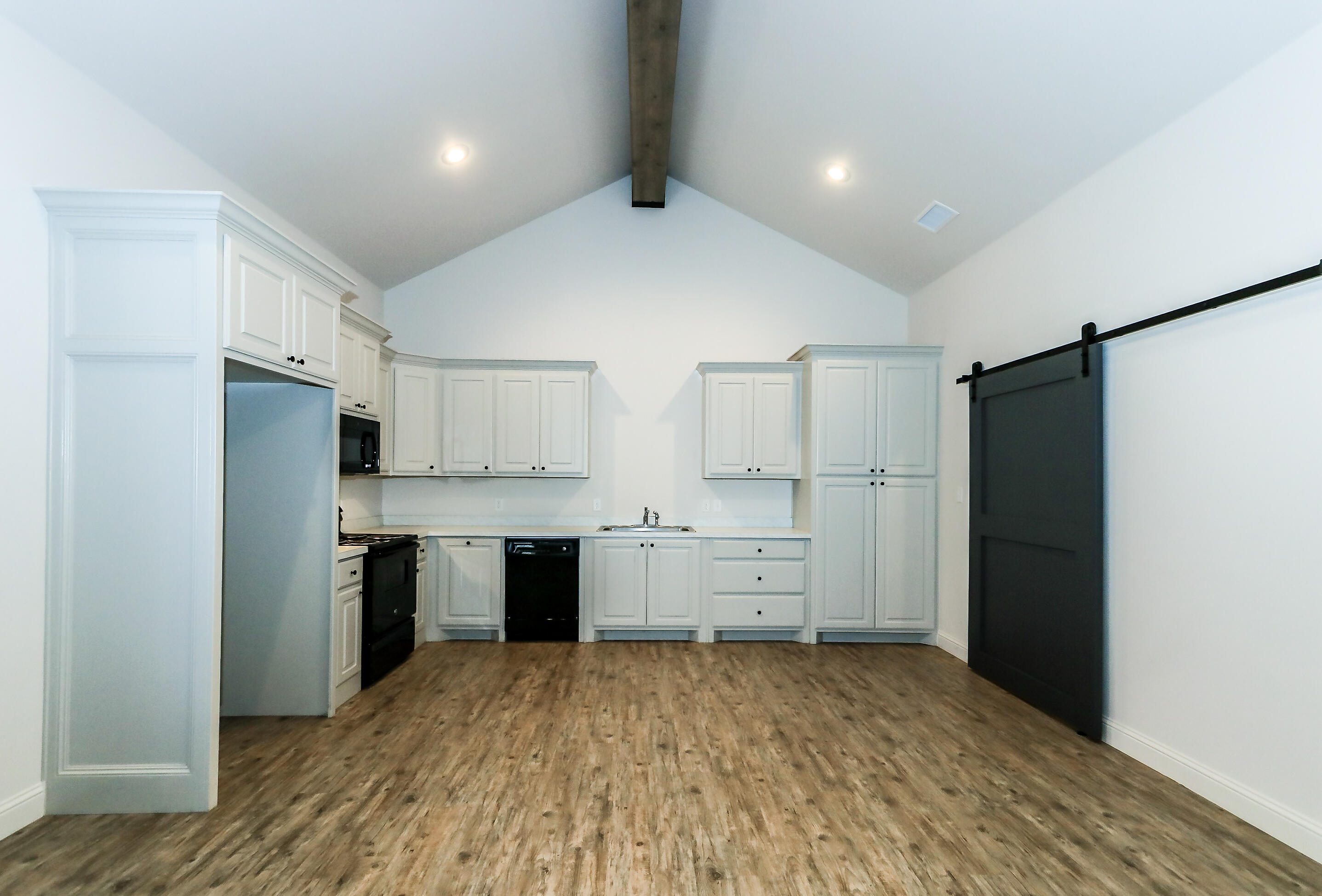 2510 112th Street, Unit B Lubbock, TX 79423 - Photo 16 of 28 a large kitchen with a refrigerator and a stove top oven