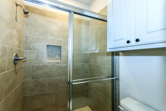a bathroom with a shower and a sink
