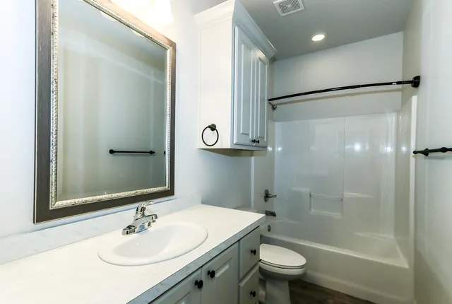 a bathroom with a sink toilet and shower