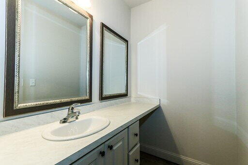 2510 112th Street, Unit B Lubbock, TX 79423 - Photo 10 of 28 a bathroom with a sink and a mirror