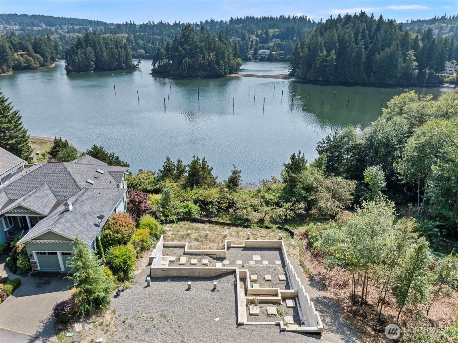 an aerial view of a house with a yard and lake view