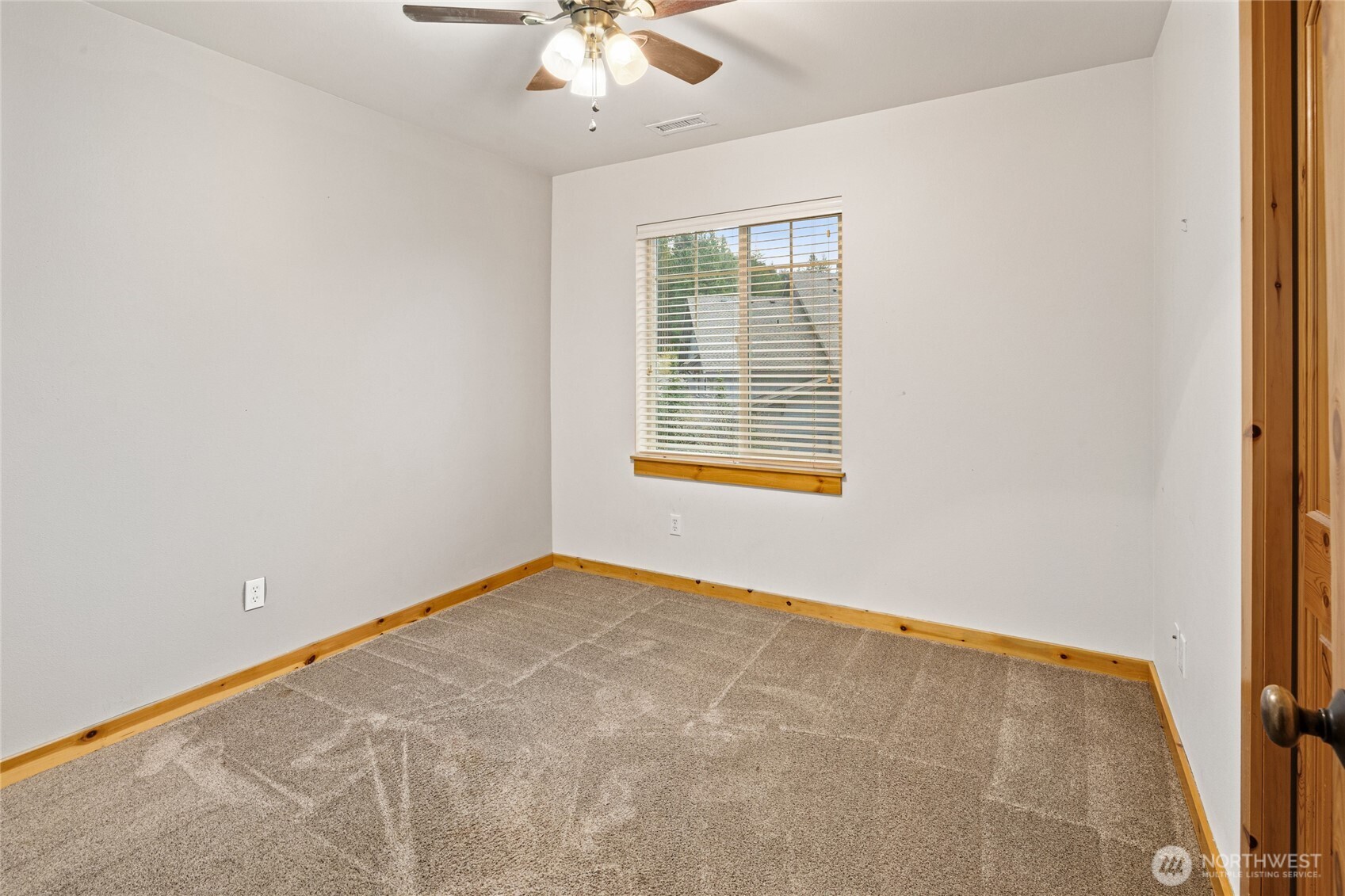 231 Clearwater Loop, Unit 1 Ronald, WA 98940 - Photo 15 of 34 an empty room with a chandelier fan and windows