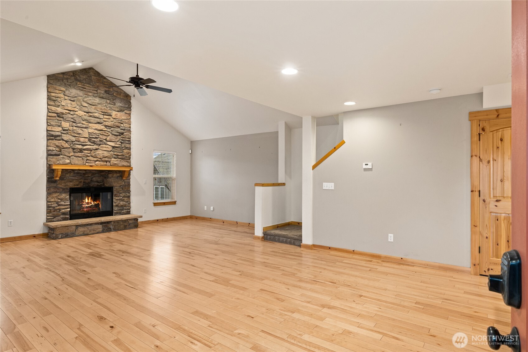 231 Clearwater Loop, Unit 1 Ronald, WA 98940 - Photo 4 of 34 an empty room with wooden floor fireplace and windows