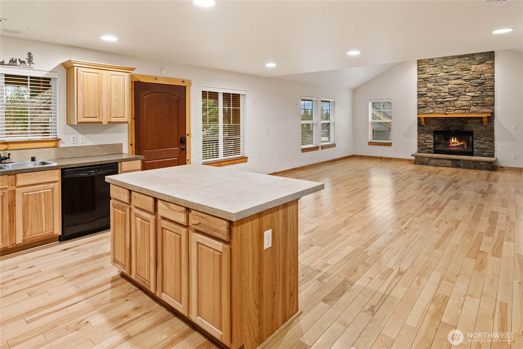 231 Clearwater Loop, Unit 1 Ronald, WA 98940 - Photo 8 of 34 an open kitchen with wooden floor and a fireplace