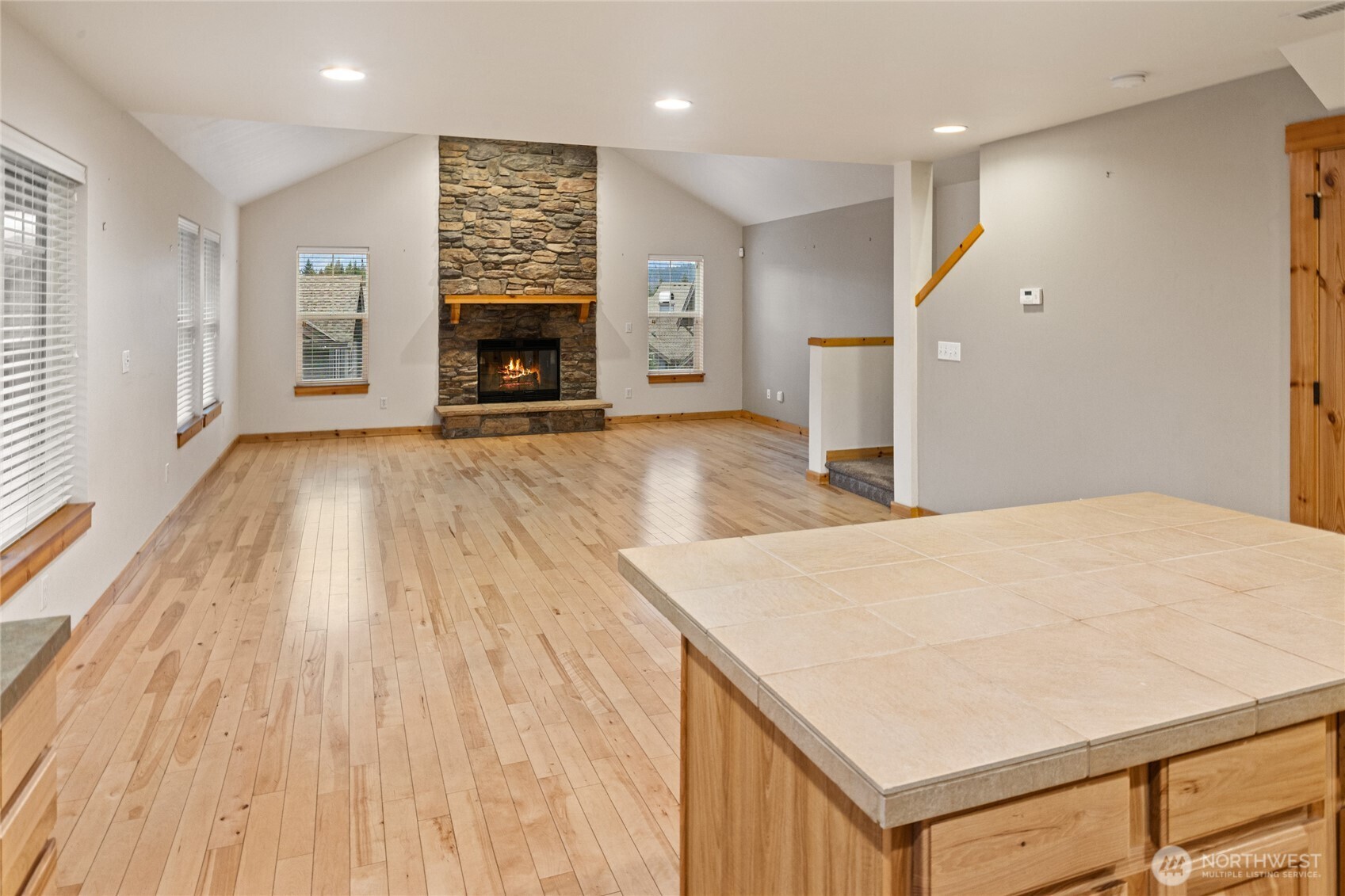 231 Clearwater Loop, Unit 1 Ronald, WA 98940 - Photo 9 of 34 an empty room with wooden floor and fireplace