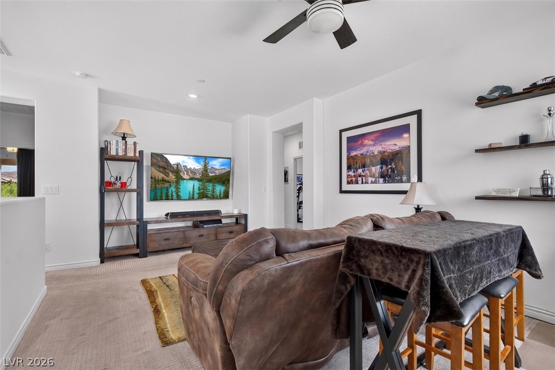 1824 Redland Ridge Street Henderson, NV 89002 - Photo 33 of 69 Relax in this living room featuring plush carpet and a stylish ceiling fan.