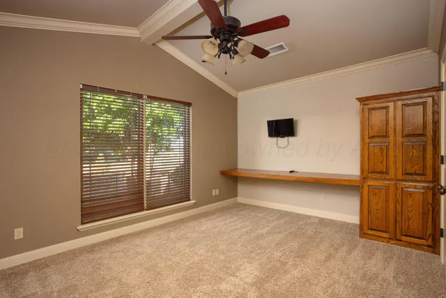 a view of a house with a yard and a garden