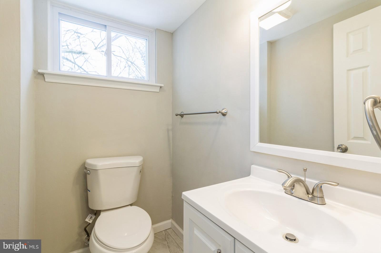 511 Schick Road Aston, PA 19014 - Photo 9 of 24 a white toilet sitting next to a bathroom sink
