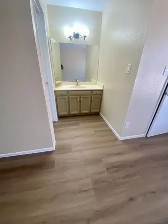 a view of a room with wooden floor and sink