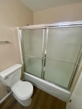 a bathroom with a toilet and a shower