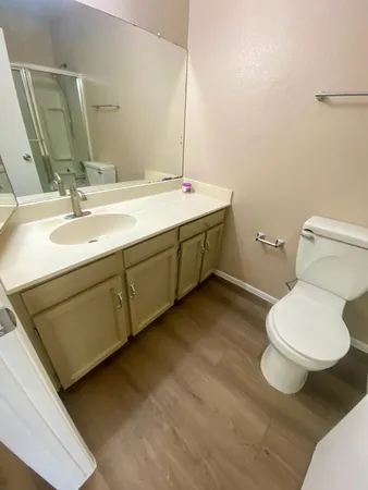 a bathroom with a sink mirror and toilet