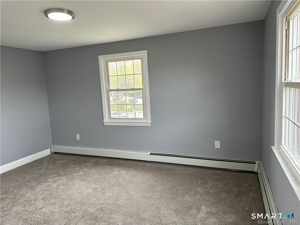12 Brewster Road, Unit C Glastonbury, CT 06033 - Photo 8 of 10 an empty room with windows