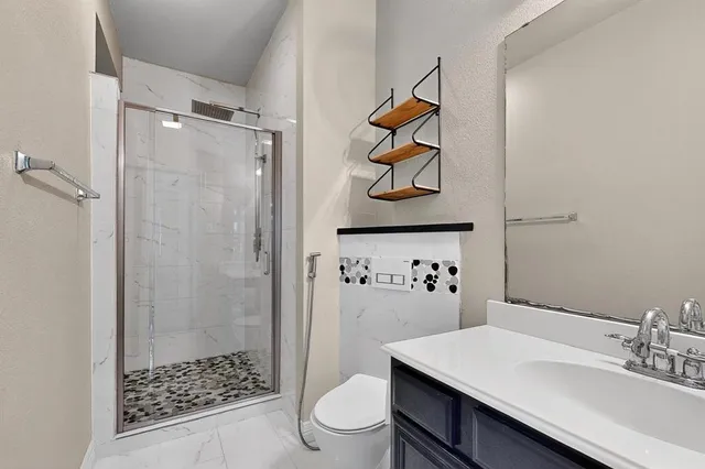 a bathroom with a sink toilet and shower