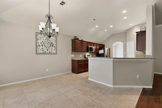 a view of a kitchen with a sink stainless steel appliances and cabinets