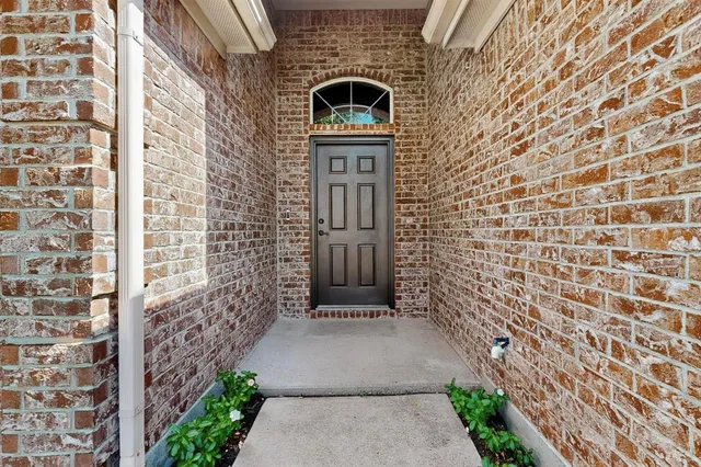 a front view of a house with a brick wall