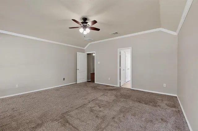a view of an empty room with a fan